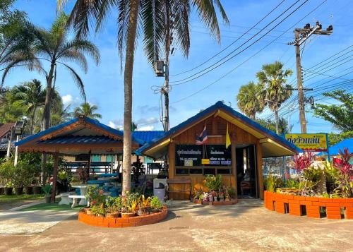 a store with palm trees in front of it at Thungwua laen resort in Chumphon