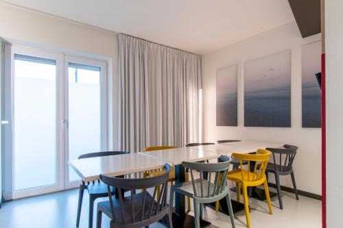a dining room with a table and chairs at ibis Budget Knokke in Knokke-Heist