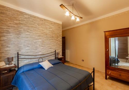 a bedroom with a bed and a brick wall at B&B La Botte - Taurasi in Taurasi