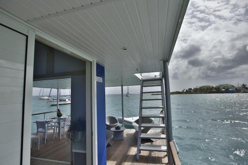a ladder on the side of a boat on the water at Aqualodge, Les Saintes, Terre de Haut in Terre-de-Haut