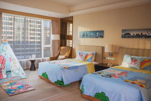 a hotel room with two beds and a large window at Crowne Plaza Guangzhou Huadu by IHG - Free Shuttle bus between hotel to Exhibition Center During Canton Fair in Guangzhou