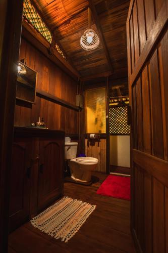 a wooden bathroom with a toilet and a sink at Ocean Forest Ecolodge in San Pedrillo