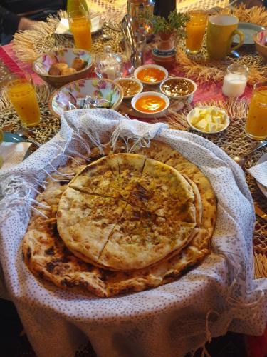 a plate of food on a table with food at Maison d'hôtes IZZA in Kalaat MGouna