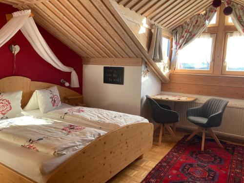 a bedroom with a bed and a table in it at Gästehaus Huber in Arbesbach