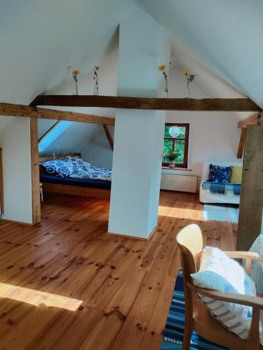a room with a loft with two beds and wooden floors at Schlaf mal im Denkmal in Birstein