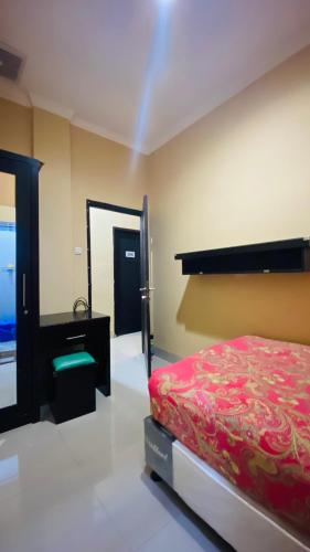 a bedroom with a bed and a mirror at Mahkota Residence - Mangga Besar in Jakarta