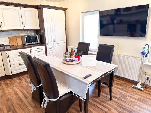 a kitchen with a dining room table with chairs at Apartement am Schloss Pillnitz in Dresden