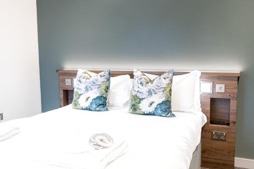 a bedroom with a large white bed with pillows at The Pheasant Inn in Grange Over Sands