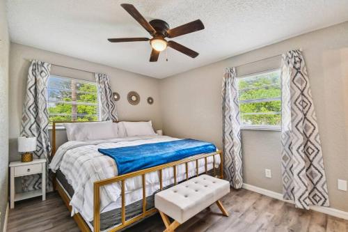 a bedroom with a bed and a ceiling fan at ~ Modern and Cozy 4BR home - 30 Mins from Disney ~ in Orlando