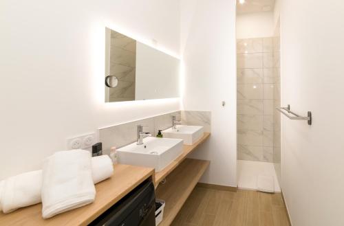 a bathroom with a sink and a mirror at La Dolive - Locationtournus in Tournus