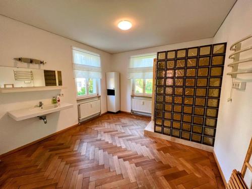 a large room with a wooden floor and windows at Gasthof - Auszeit im Bad Diezlings - Adults only in Hörbranz