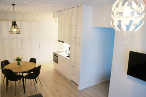a kitchen and dining room with a table and chairs at Snow Queen's residence in Rovaniemi