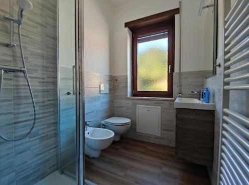 uma casa de banho com um WC, um lavatório e um chuveiro em Residence Avila em Gallio
