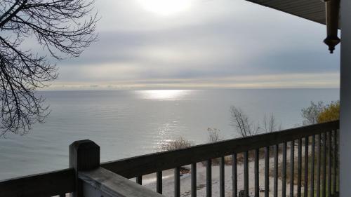 a view of the ocean from the porch of a house at Algoma Beach Motel in Algoma