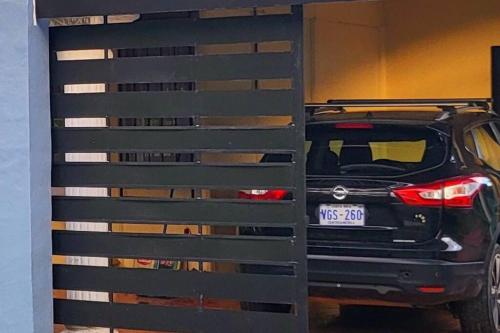 a car parked in a garage next to a fence at Casa Congo in Golfito
