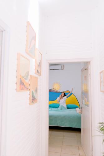 a woman laying on a bed in a room at Roemah Renjana Yogyakarta in Timuran