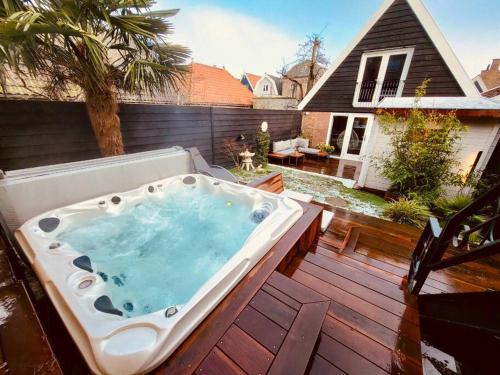 a hot tub sitting on top of a deck at Charming house w/ private wellness, near Amsterdam in Monnickendam