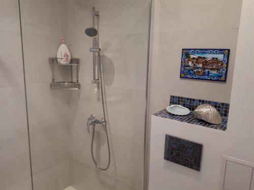 a shower with a glass door in a bathroom at Obzor Tatyana Apartaments Bonjour in Obzor