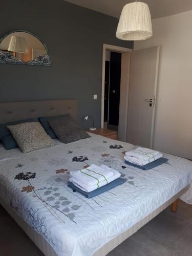 a bedroom with a bed with towels on it at Obzor Tatyana Apartaments Bonjour in Obzor