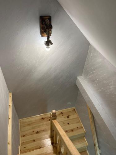 a staircase with a light and a wooden stair case at Vila Vodice Zlatibor in Vodice