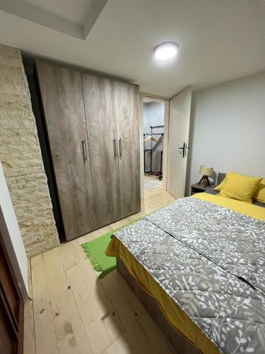a bedroom with a bed and wooden cabinets at Vila Vodice Zlatibor in Vodice