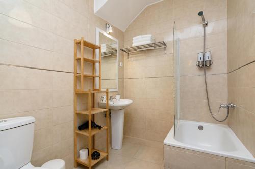 a bathroom with a shower toilet and a sink at Setúbal Downtown Apartments in Setúbal