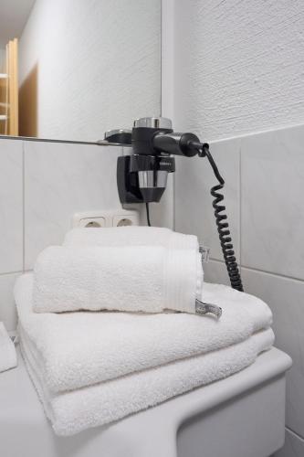 a bathroom with a blow dryer on top of a toilet at Appartementhaus Casamarai in Saalbach Hinterglemm
