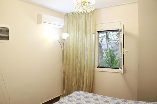 a bedroom with a bed and a window at Апартаменты Пластира in Athens