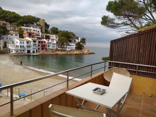 a balcony with a table and a view of the ocean at SATUNA BEACH CASA in Begur