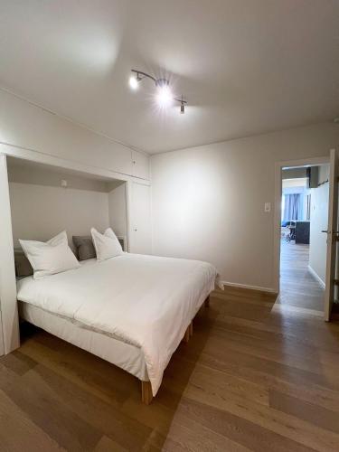 a bedroom with a large white bed in a room at Casa Casino Oostende in Ostend