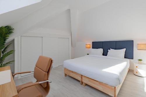 a bedroom with a bed and a desk and a chair at Good Vibes Apartment in Setúbal
