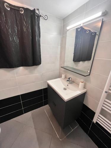 a bathroom with a sink and a mirror at Belle île in Villers-le-Lac