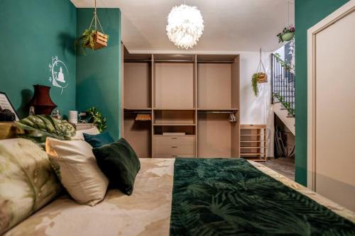 a bedroom with a large bed with green walls at Idromassaggio Doppia - Dimora Zen Seregno in Seregno