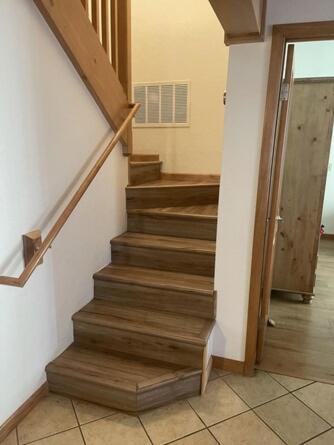 a staircase in a house with a door and a stair case at Cozy Flagstaff Home in Cool Pines - Country Club in Flagstaff