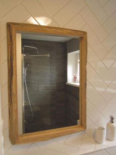 a mirror in a bathroom with a shower at Mezonetový apartmán se dvéma balkóny a výhledem in Loučná pod Klínovcem