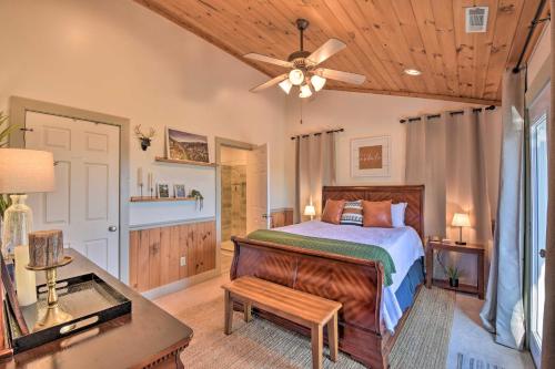 a bedroom with a bed and a ceiling fan at Lakemont Mtn Cabin with Game Room and Hot Tub! in Lakemont