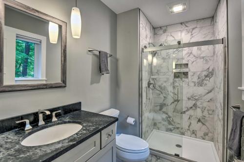 a bathroom with a sink and a shower at Modern Francestown Retreat on Scobie Pond! in Francestown
