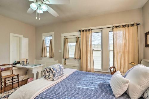 a bedroom with a bed and a desk and windows at Georgetown Vacation Rental Close to Town Square! in Georgetown