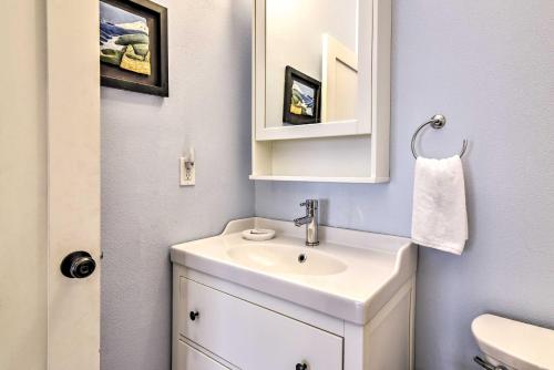 a bathroom with a white sink and a mirror at Pet-Friendly Oregon Abode - Furnished Balcony in Portland