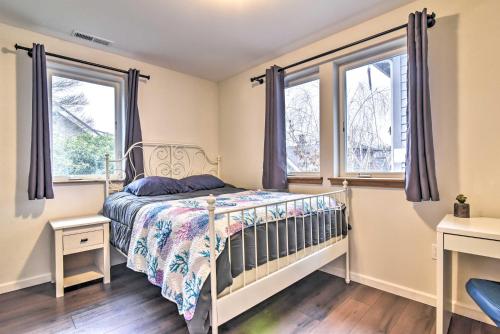 a bedroom with a bed and two windows at Pet-Friendly Oregon Abode - Furnished Balcony in Portland