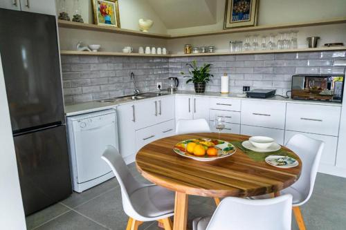 a kitchen with a wooden table with a bowl of fruit on it at Verdant Hills in Reebok