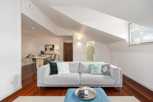a living room with a couch and a table at Setubal Downtown N97, By Home Match in Setúbal