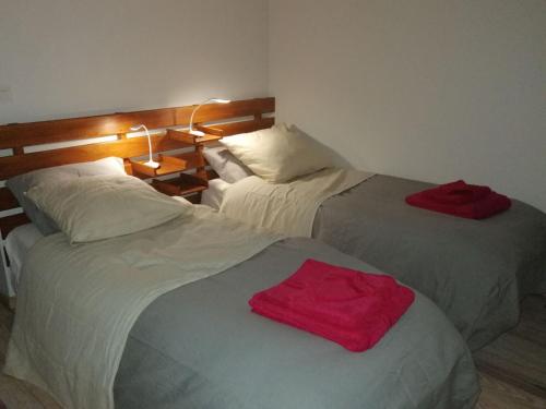 two beds sitting next to each other in a room at LES JARDINS CELESTES in Saint-Genest-de-Bauzon