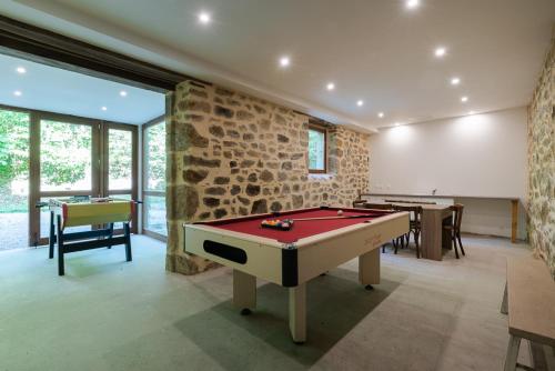 a gaming room with a pool table and two tables at Gites de La Soulière in Aubin