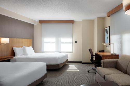 a hotel room with two beds and a desk at Hyatt Place New Orleans Convention Center in New Orleans