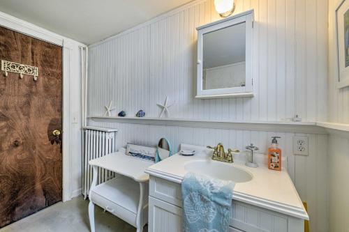 a white bathroom with a sink and a mirror at Seaside Park Apt with Outdoor Shower- Walk to Beach! in Seaside Park