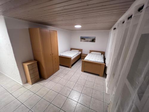 a room with two beds and cabinets in it at Familie Ising in Wörnitz