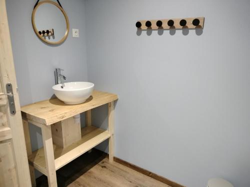 a bathroom with a sink and a mirror at ô Doux Comtois in Les Fourgs