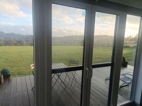 a sliding glass door with a view of a porch at Le Grand Biseu in Stavelot