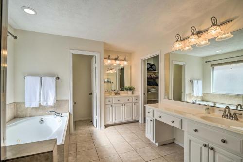 a bathroom with a tub and two sinks and a bath tub at 2,500 Sq Ft Townhome - Walk to Central River Oaks! in Houston